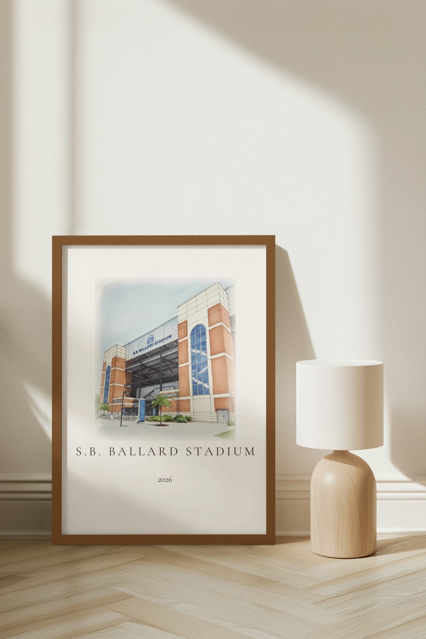 An ink and wash illustration of S.B. Ballard Stadium framed and leaning on a minimalist herringbone floor with afternoon light.